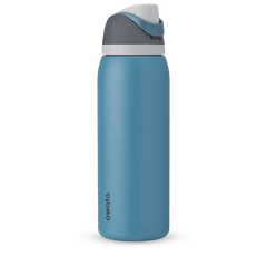 FreeSip 40oz in Blue Oasis, denim blue body with matching blue carry loop, dark gray flip cap, and white accent band